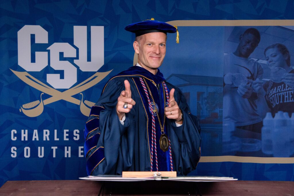 President Dondi Costin in regalia giving a double thumbs up towards the camera.