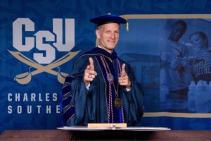 President Dondi Costin in regalia giving a double thumbs up towards the camera.