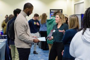 Students at the career fair and discussing about job opportunities