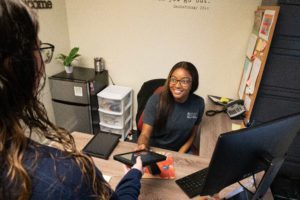 A woman gives the iPad to another woman