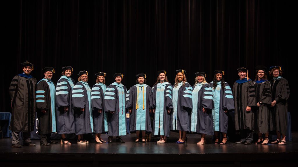 Doctoral candidates and faculty pose following the College of Education Graduate School Commencement