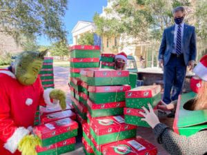 President Dondi Costin assists with transporting donated Operation Christmas Child shoeboxes at Charleston Southern University