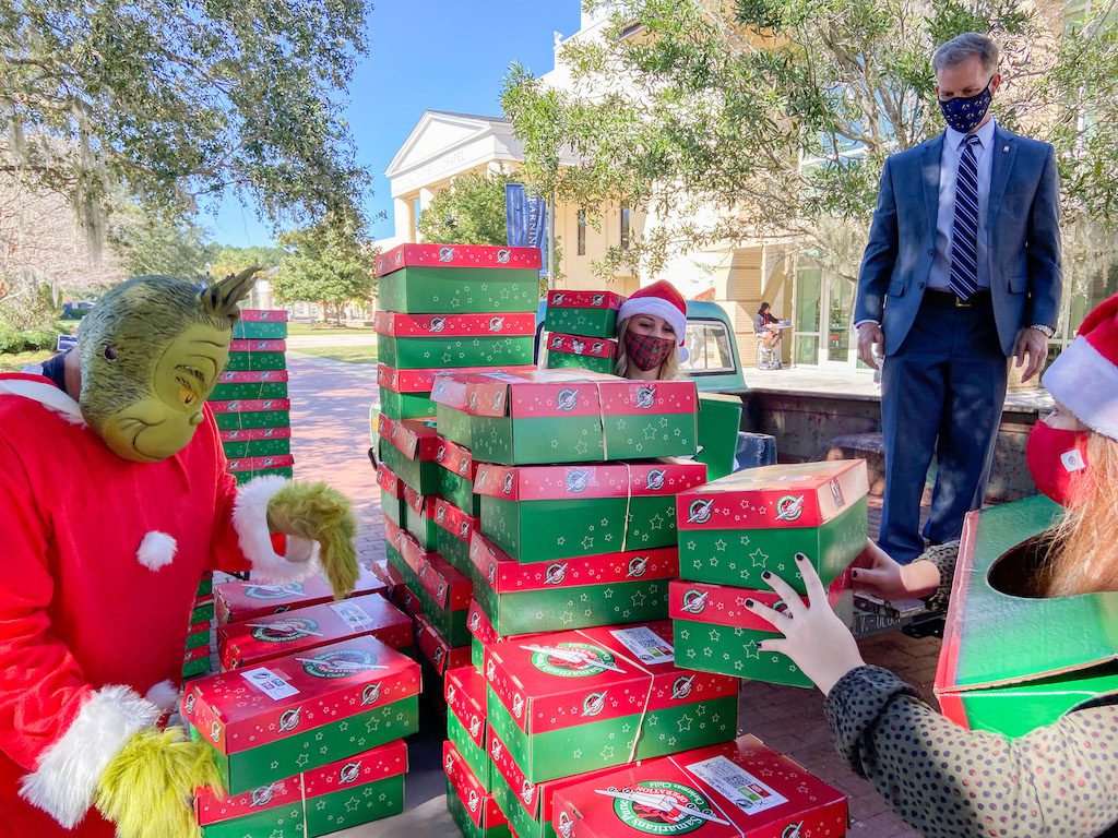 President Dondi Costin assists with transporting donated Operation Christmas Child shoeboxes at Charleston Southern University