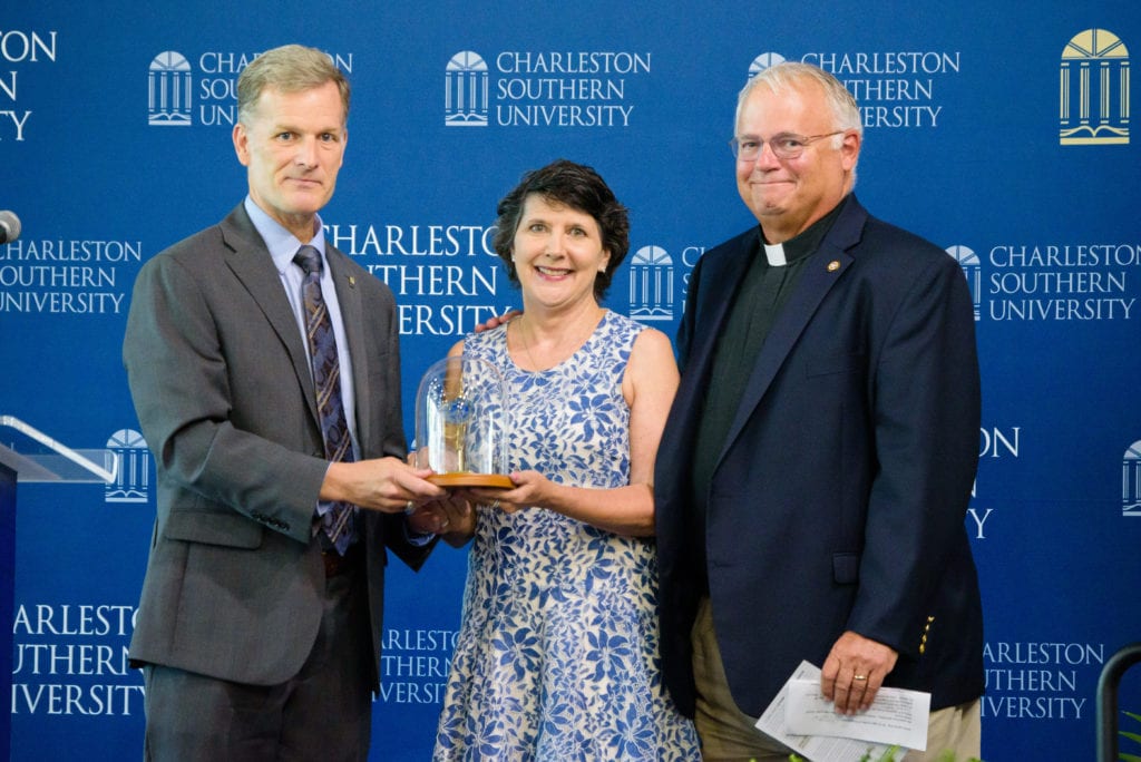 CSU President Dondi Costin presents a gift of appreciation to the Rev. Rob and Kathy Dewey