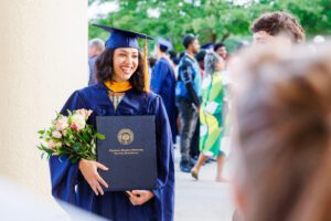Master's graduate poses for photo at Charleston Southern