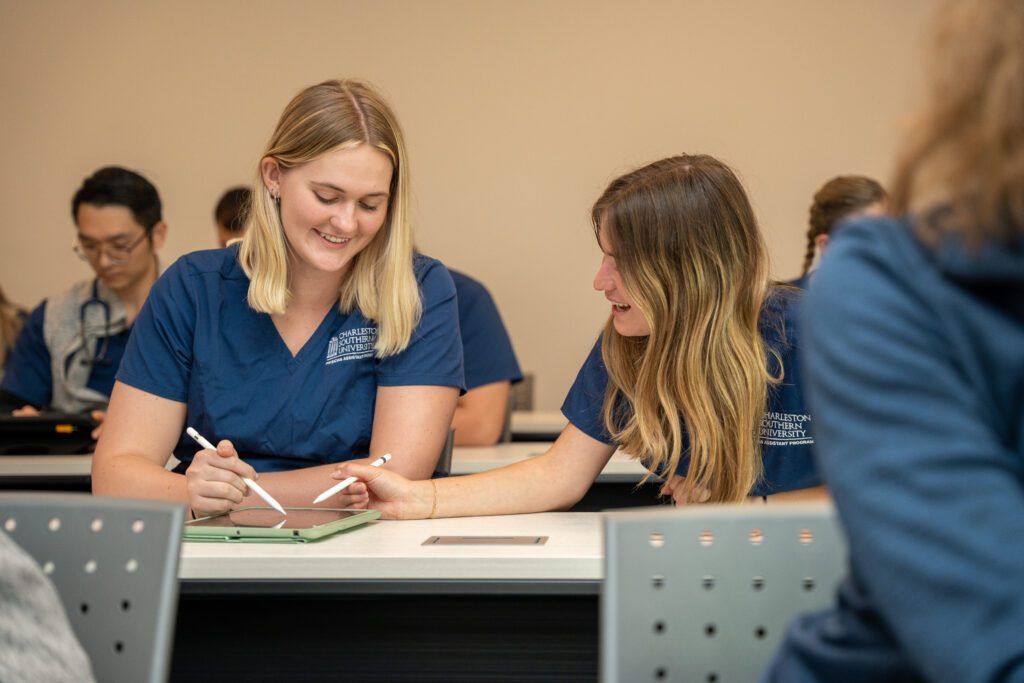 Two nursing students discussion the material in class