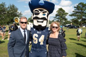President Dr. Dondi Costin and First Lady Vickey Costin with Bucky at 2021 Homecoming