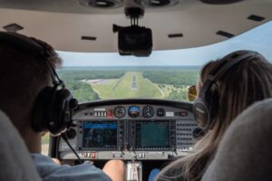 Two aeronautics students operate aircraft in a test flight.