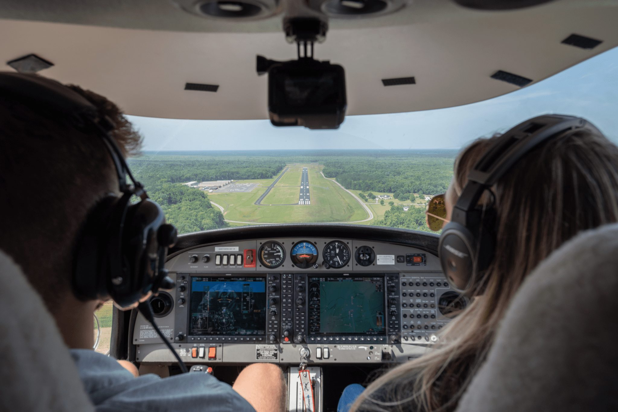 Two aeronautics students operate aircraft in a test flight.