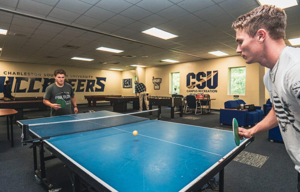 Two boys playing pingpong in the Brewer center.