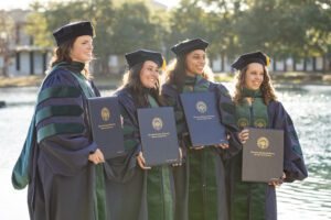 Graduates from the Charleston Southern DPT program pose after the ceremony by the Reflection Pond