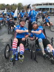 Matthew Shelton fist bumps after a bike race