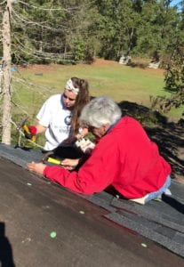 Maxwell Rollins with a student at a Habitat build day in fall 2018.