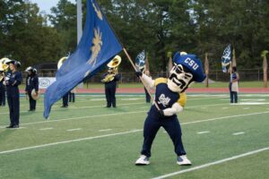 Bucky swings the CSU flag over the fifty yard line