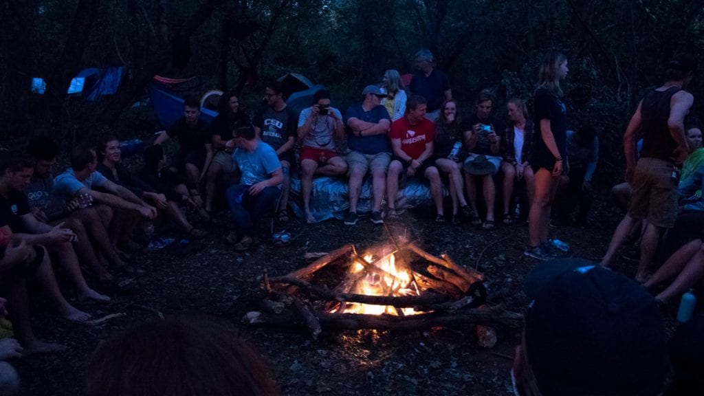 The CSU Outdoor Adventure Club camps out by a fire