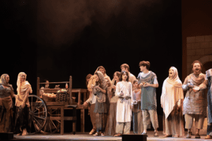 Many people performing a play on stage