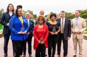 Alumni's group received an award, with the point in the background