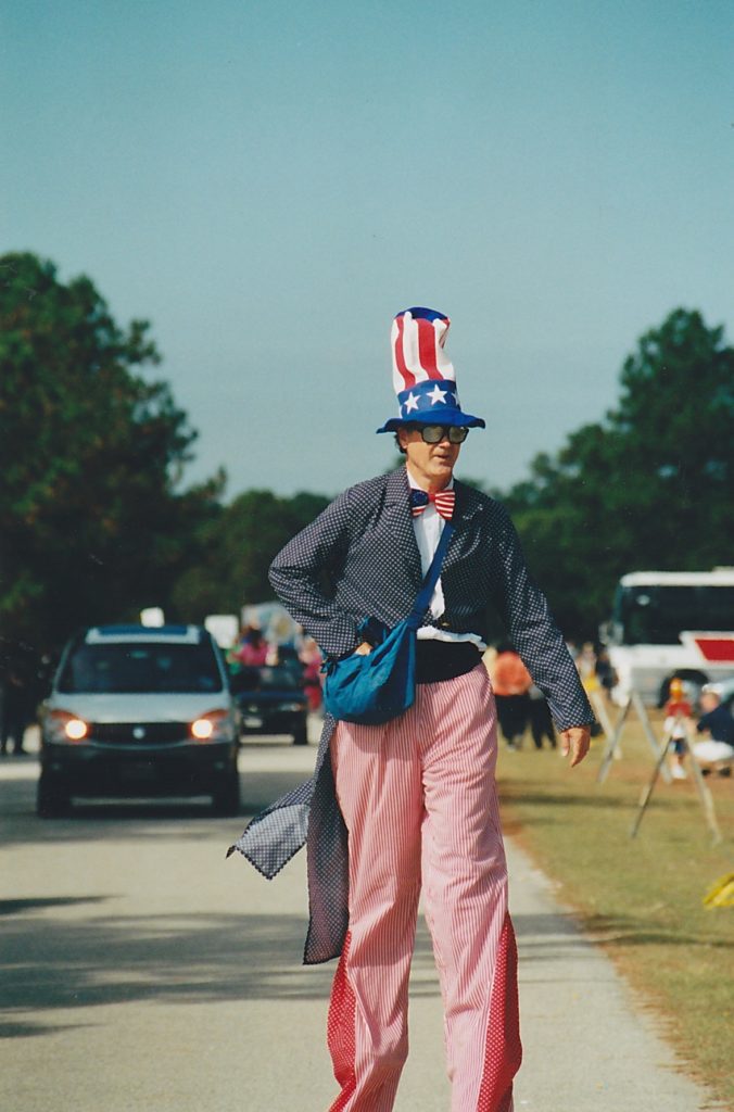 Arnold Hite on stilts at a parade