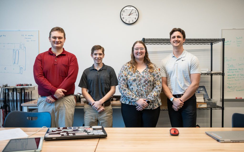 Samuel Wand, Braden Siegal, Keara Walsh, and Jonathan Gaminde present their senior project robot design.