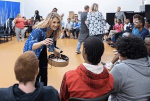 CSU alum Catherine Nielsen leads a drum circle for students of all abilities in a school setting.