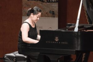 Yun playing piano at a piano festival