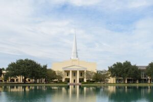 An image of the chapel and surrounding buildings from across the reflection pond