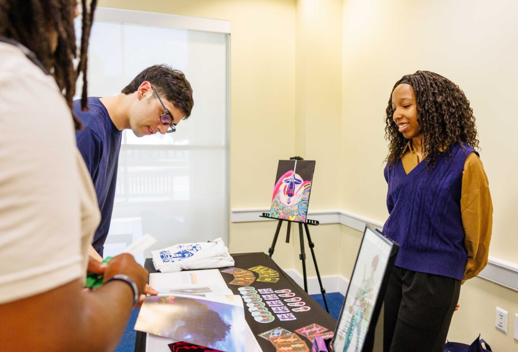 Graphic design student showcasing her portfolio at Charleston Southern University.