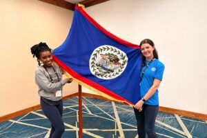 Two Charleston Southern females displaying a flag.