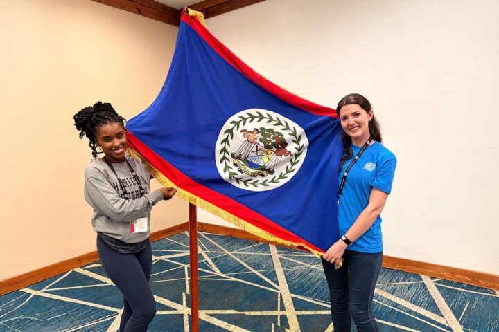 Two Charleston Southern females displaying a flag.